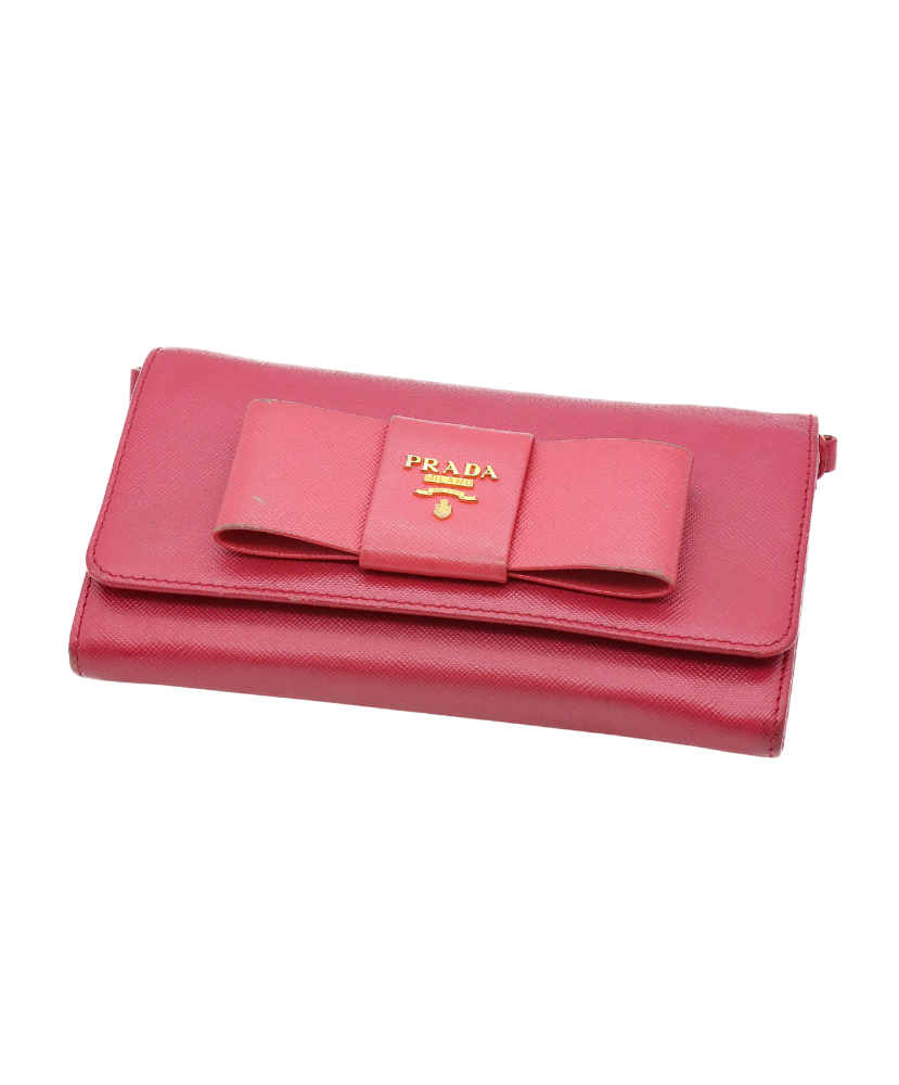 Pink Prada wallet with a bow on a white background