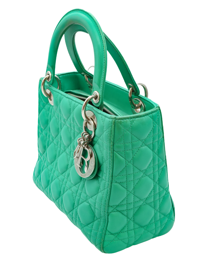 Green Dior quilted handbag with a silver chain and clasp on a white background