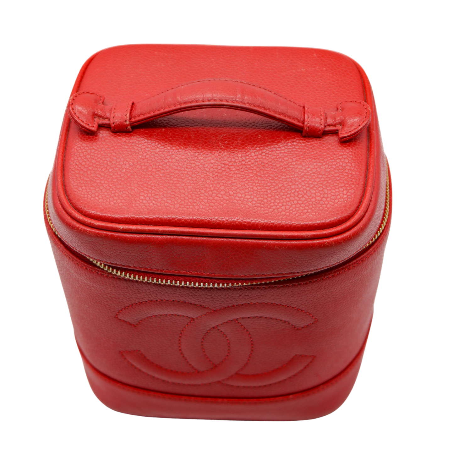 Red leather travel case with Chanel logo on a white background