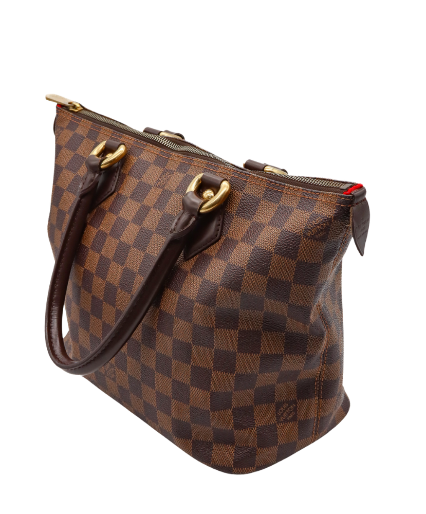 Brown Louis Vuitton checkered handbag with gold accents on a white background