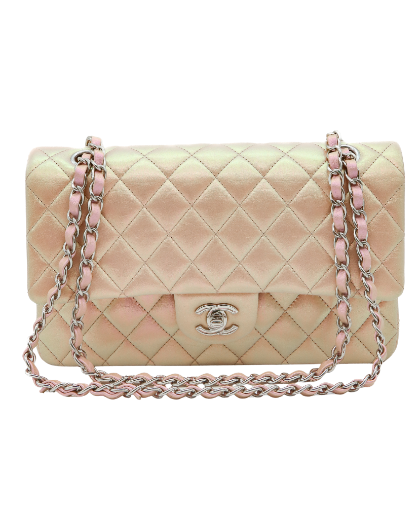 Quilted Chanel handbag with pink chain strap on a white background