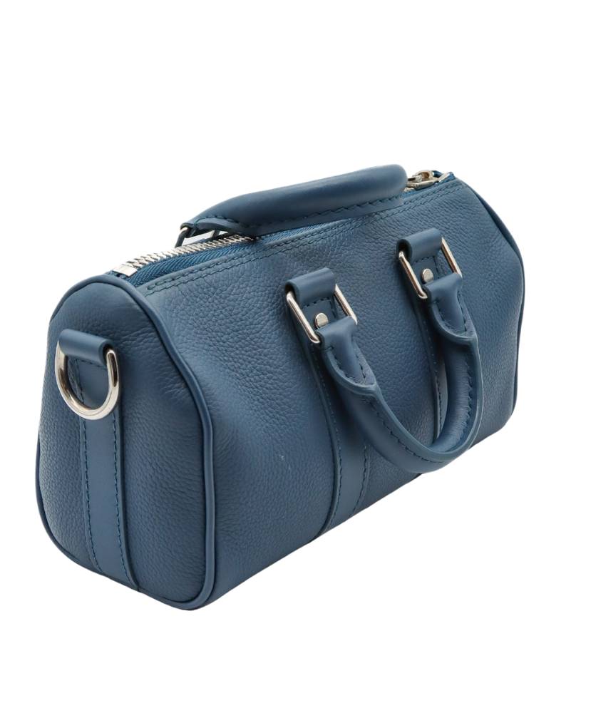 Blue Louis Vuitton luggage bag with silver buckles on a white background