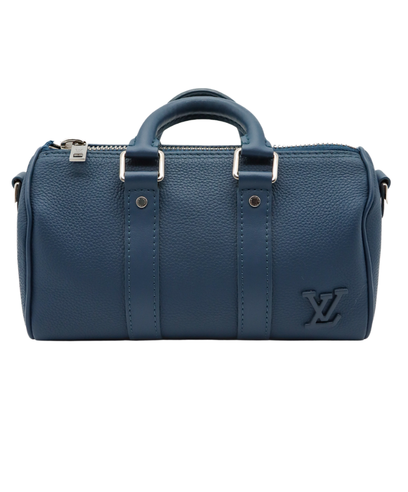 Blue Louis Vuitton luggage bag with silver buckles on a white background
