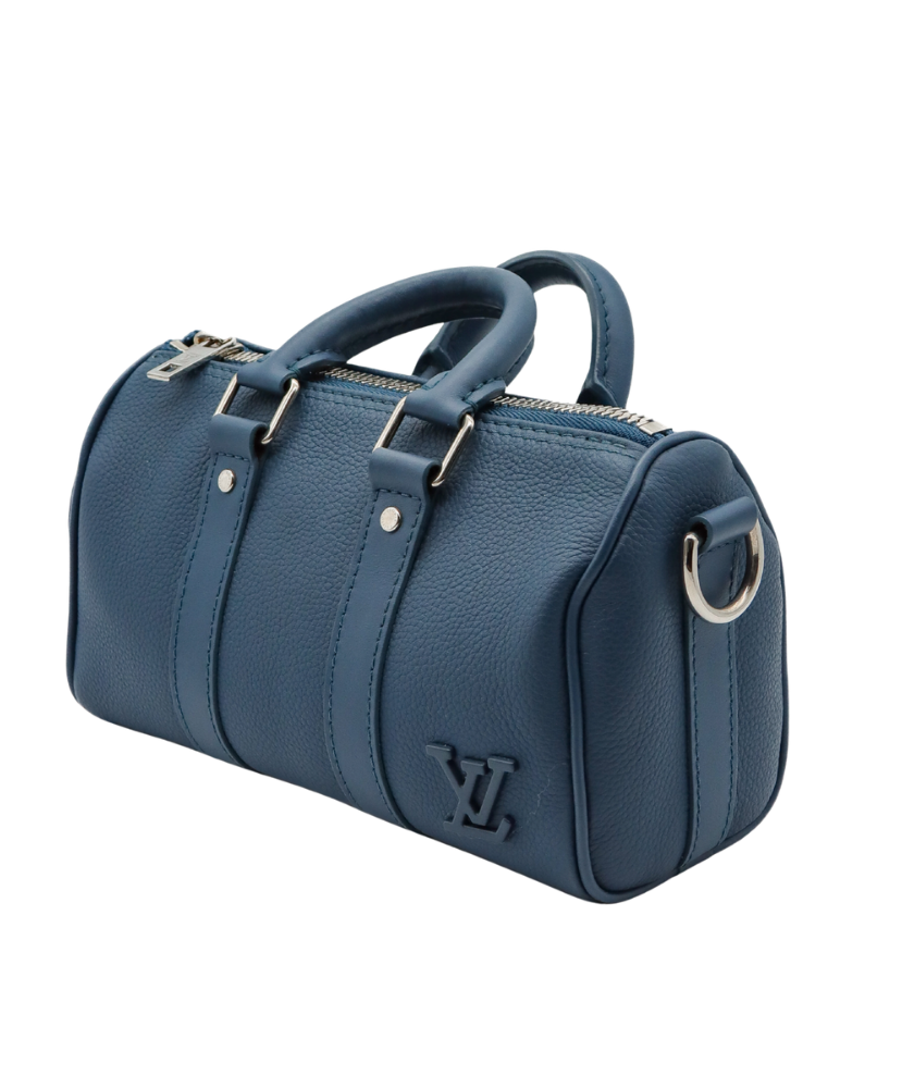 Blue Louis Vuitton luggage bag with silver buckles on a white background