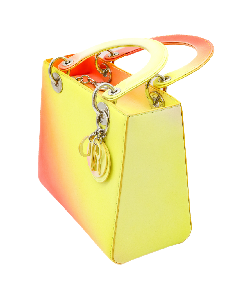 Gradient yellow to Red Dior handbag with a visible brand logo on a white background