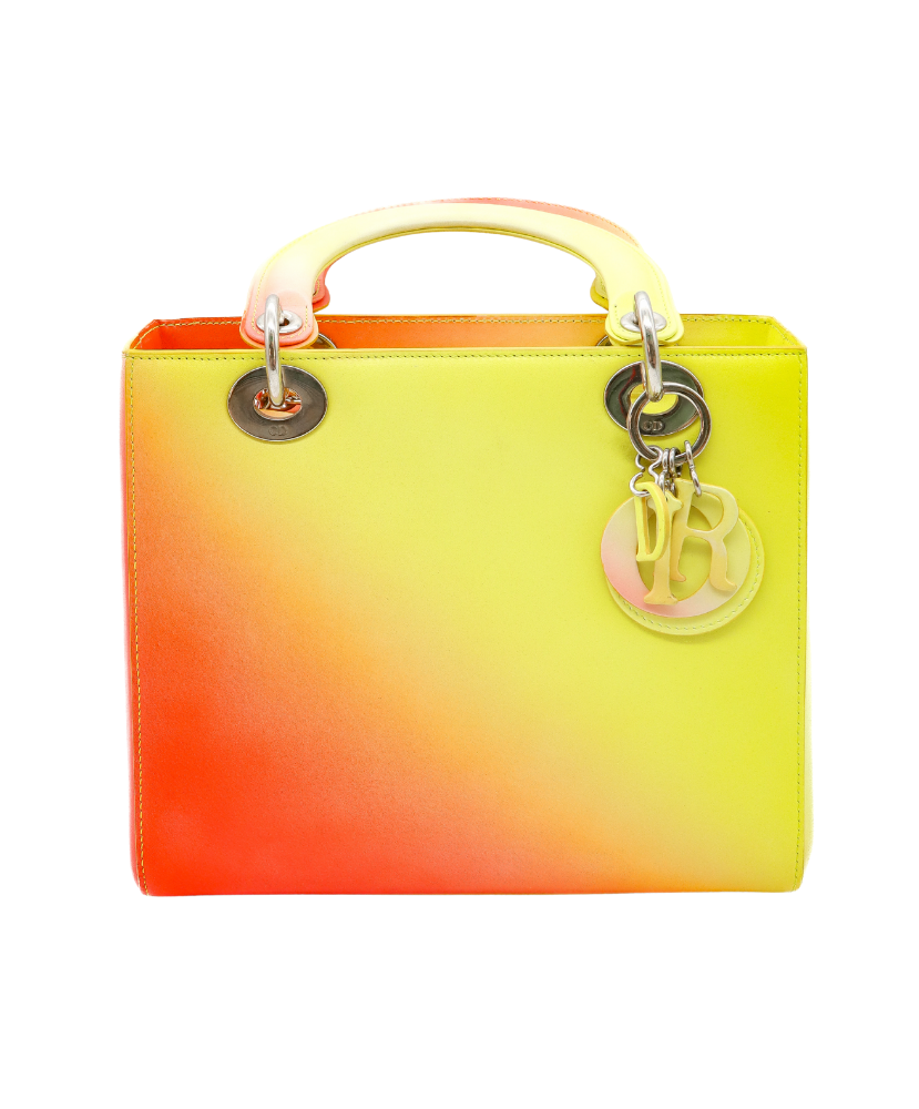 Gradient yellow to Red Dior handbag with a visible brand logo on a white background