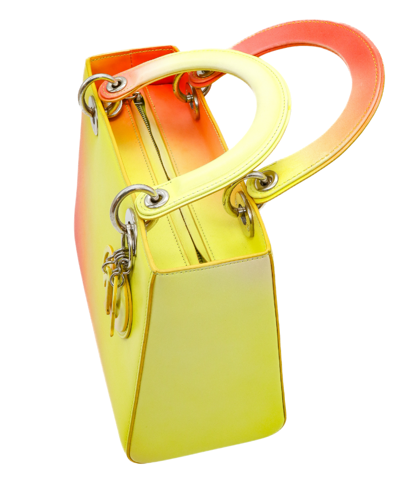 Gradient yellow to Red Dior handbag with a visible brand logo on a white background