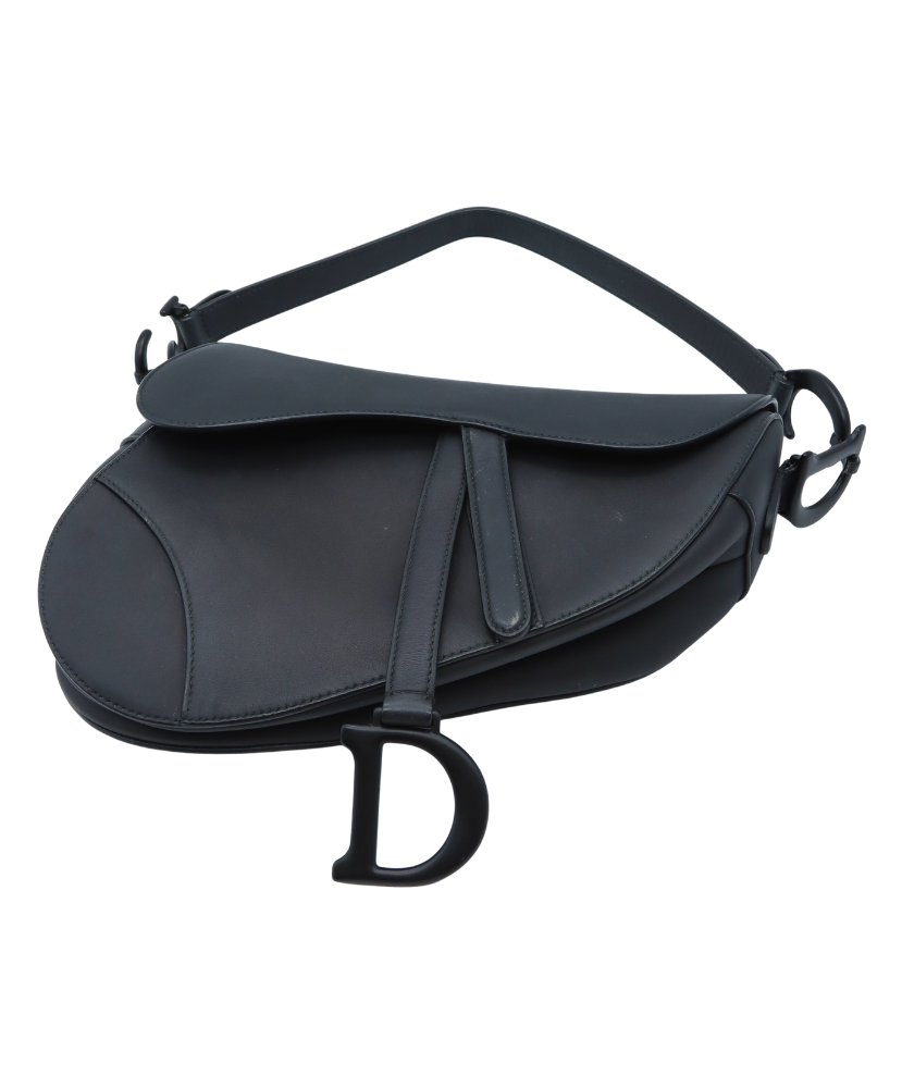 Black Dior saddle-shaped bag with a visible brand logo on a white background