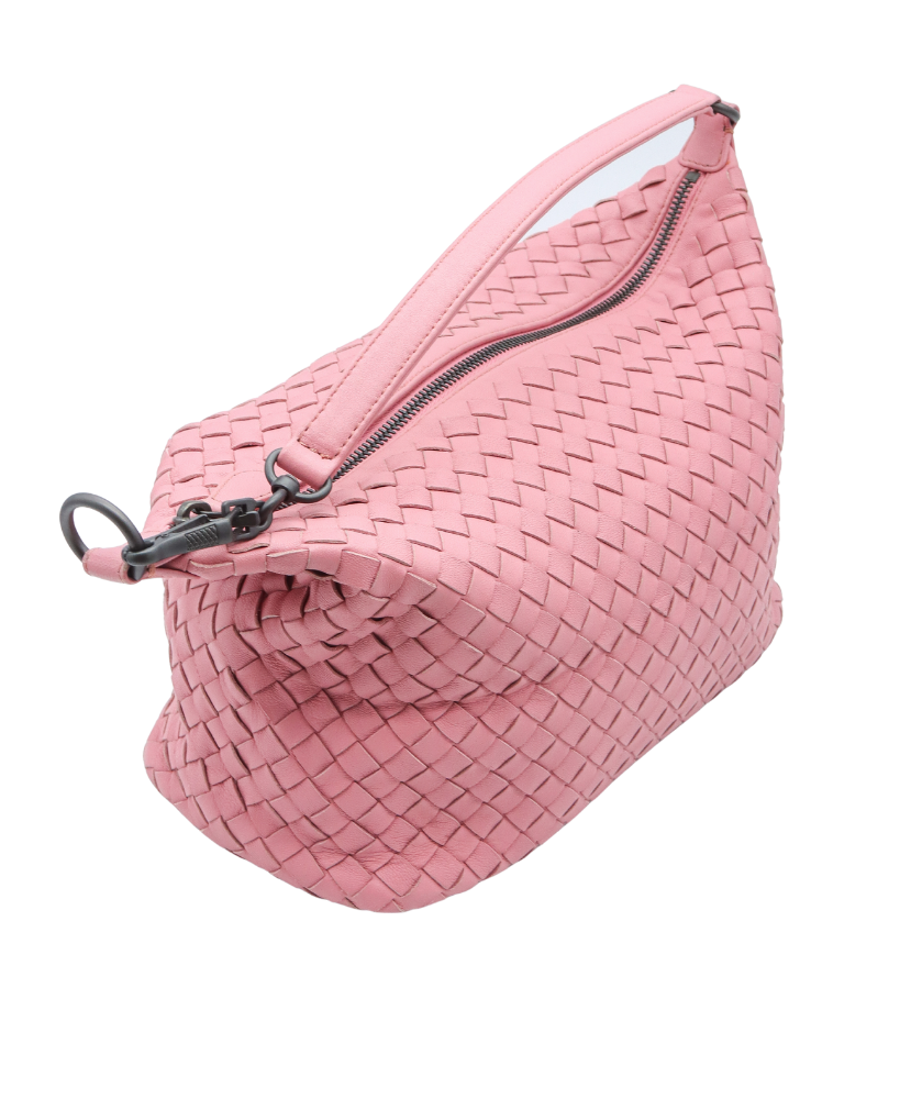 Pink Bottega woven waist bag with a zipper on a white background