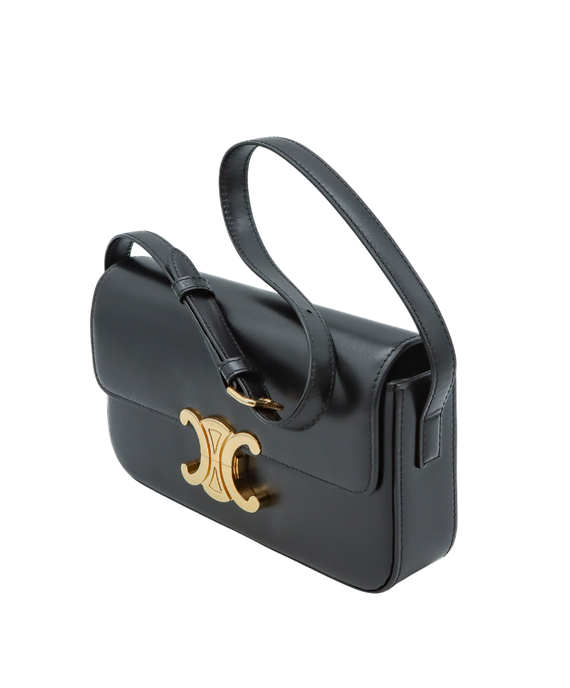 Black Celine handbag with a gold clasp on a white background