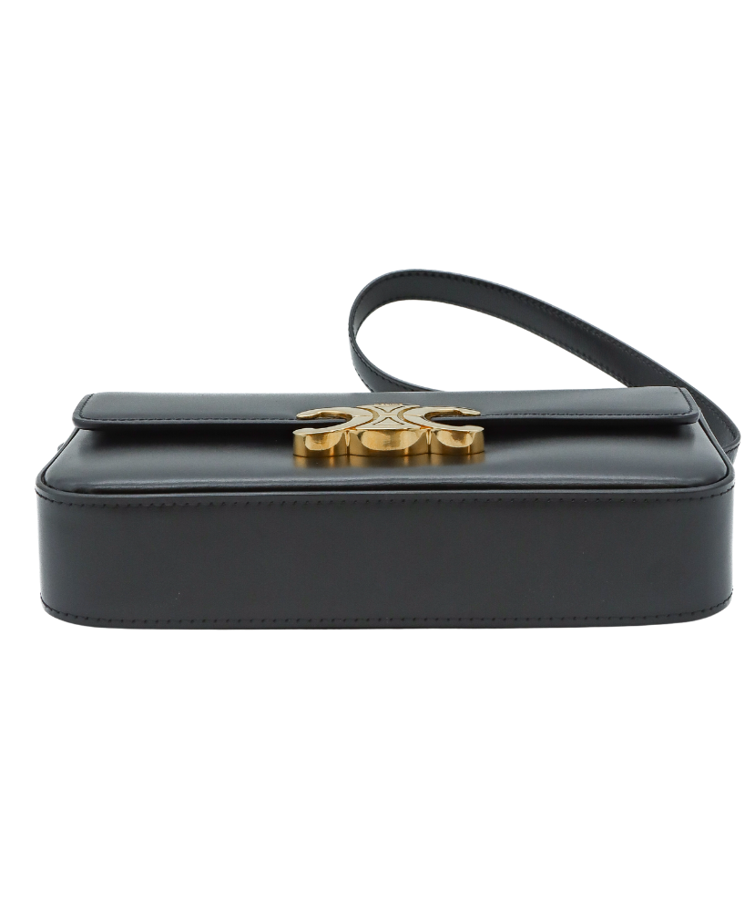 Black Celine handbag with a gold logo on a white background