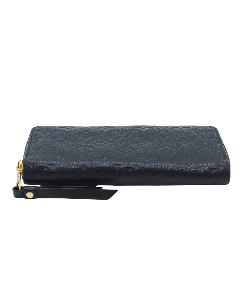 Black Louis Vuitton wallet with gold zipper on a white background