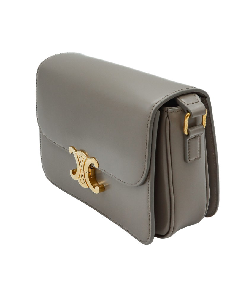 Celine Gray handbag with a gold clasp on a white background