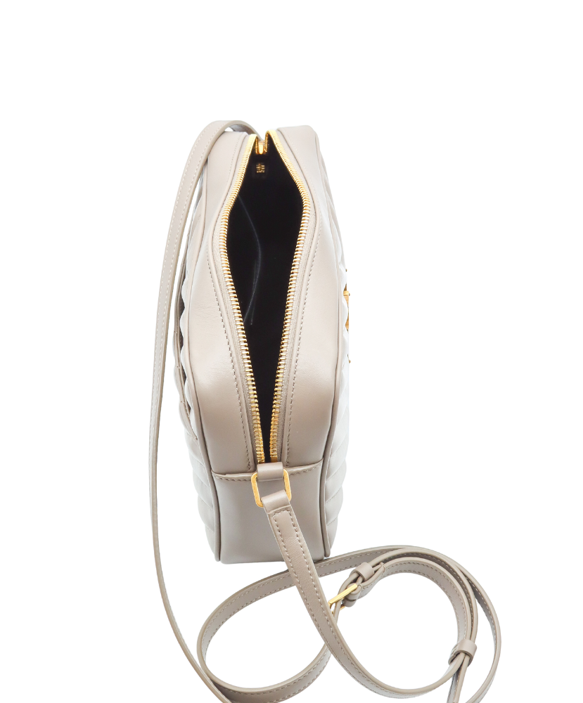 Beige Saint Laurent handbag with a gold logo on a white background