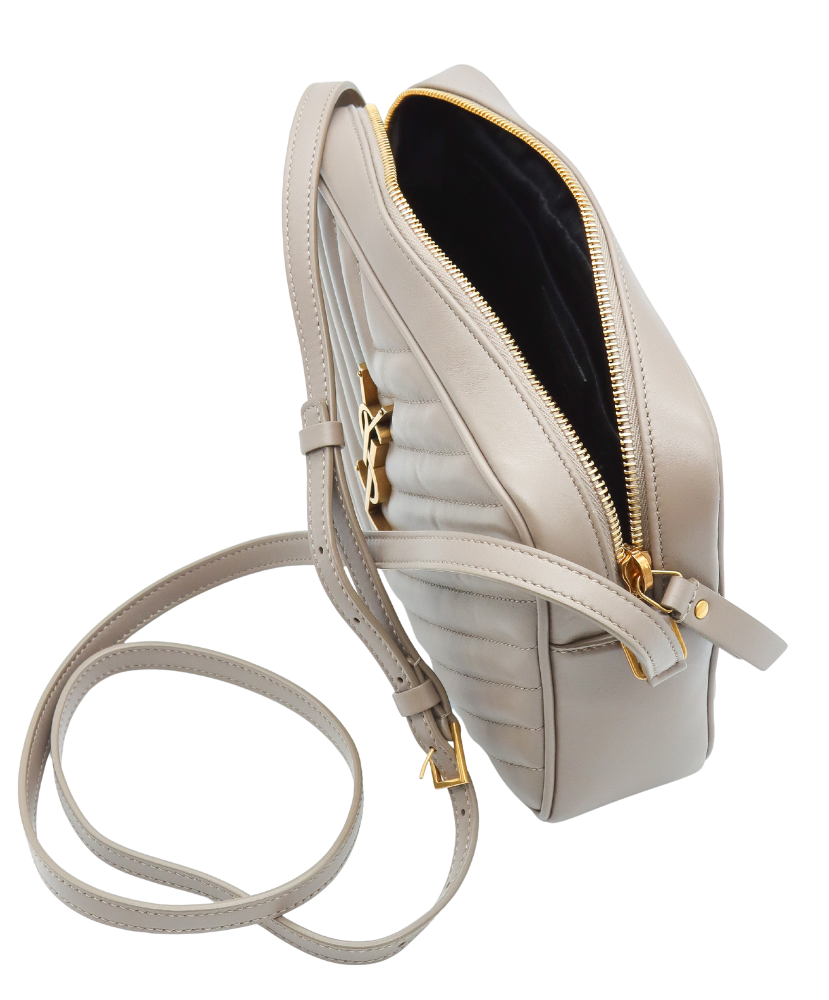 Beige Saint Laurent handbag with gold logo on a white background