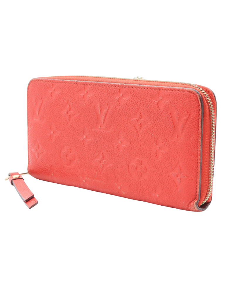 Red Loius Vuitton wallet with brand logo on a white background